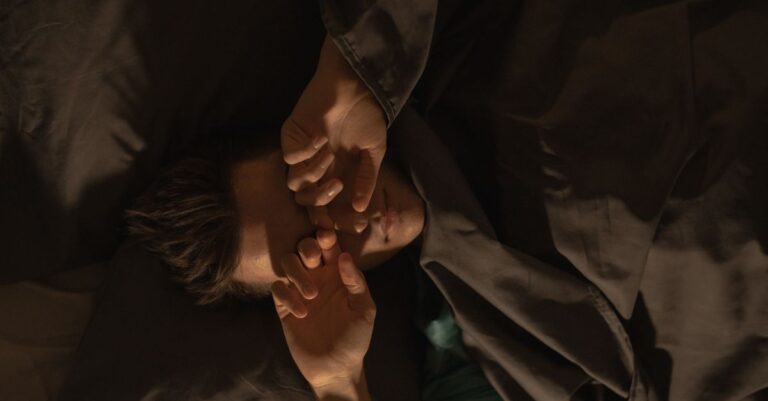 Una persona despertándose en su cama, reflejando la falta de energía y el impacto emocional que puede tener.